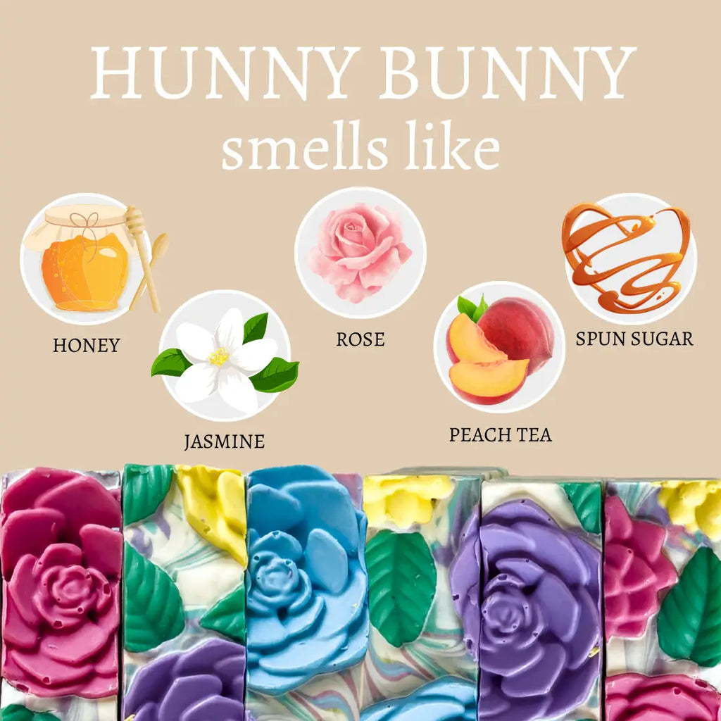 Colorful soap bars with scents labeled as honey, rose, spun sugar, jasmine, peach tea on a beige background.