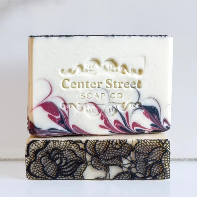Two soap bars with marbled designs stacked on a white background, featuring 'Center Street Soap Co' branding.