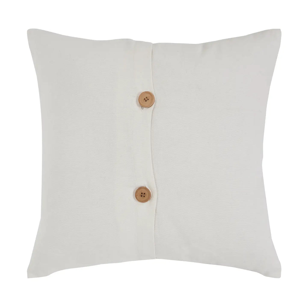 White pillow with two wooden buttons on a white background