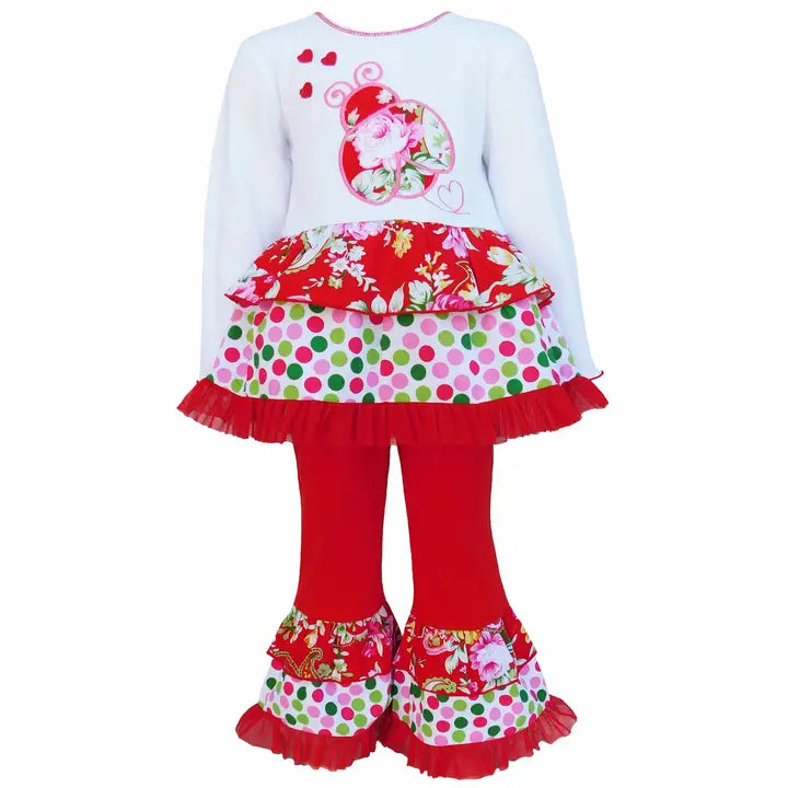 Children's outfit with floral top and red pants on a white background