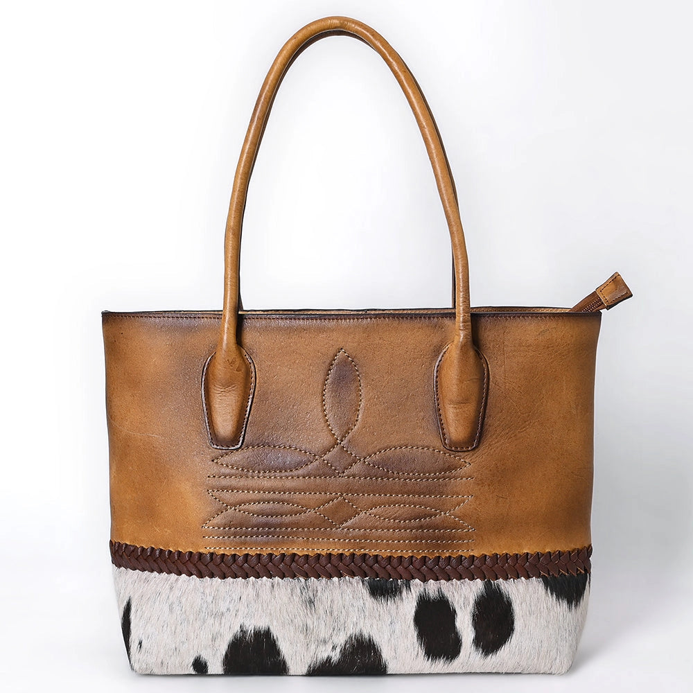 Brown leather tote bag with cowhide pattern on a white background