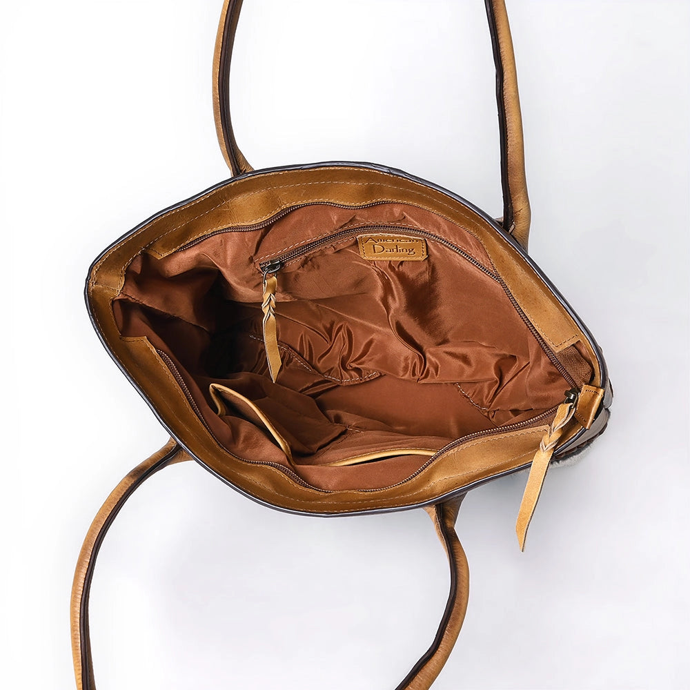 Brown leather handbag with visible brand logo on a white background