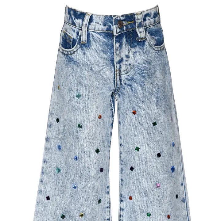 Blue jeans with colorful embellishments on a white background