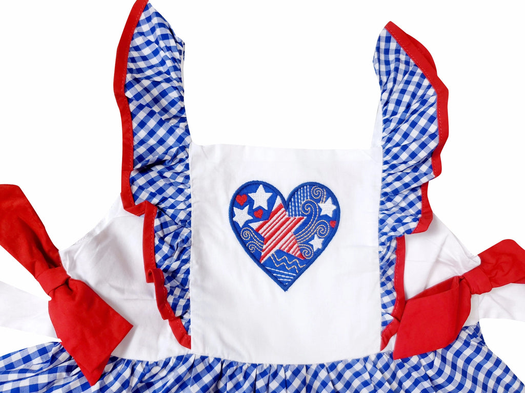 Children's outfit with red, white, and blue checkered design and heart-shaped American flag graphic.