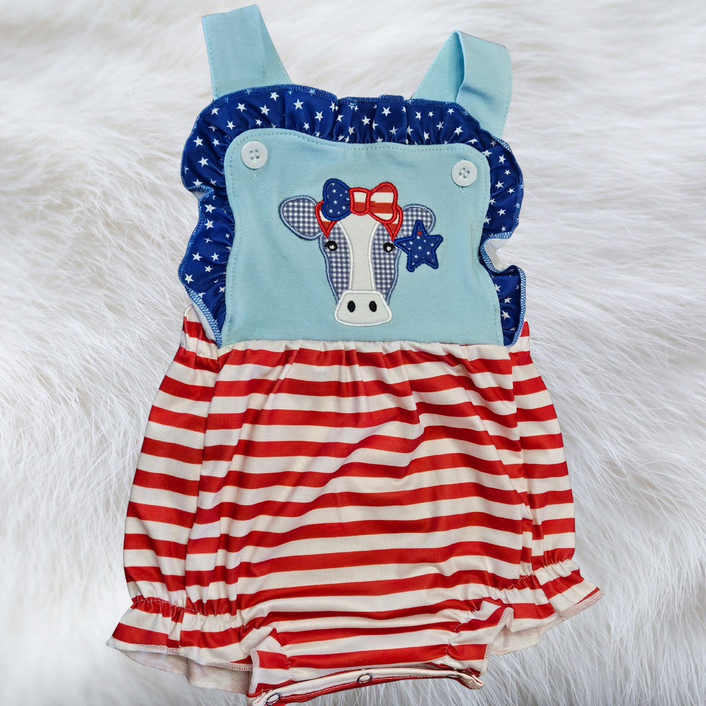 Children's romper with American flag design on a white fur background