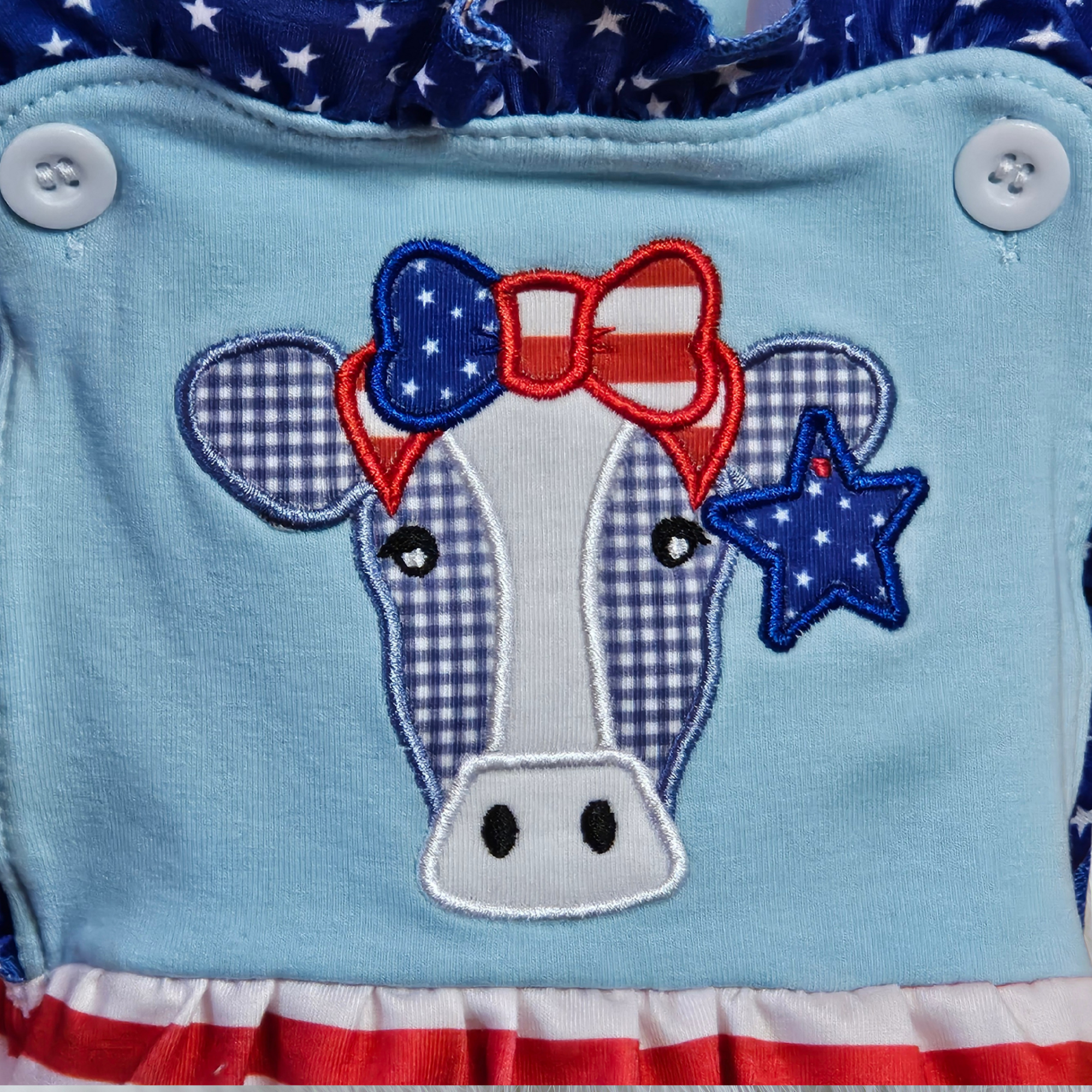 Cow design with American flag elements on a blue background