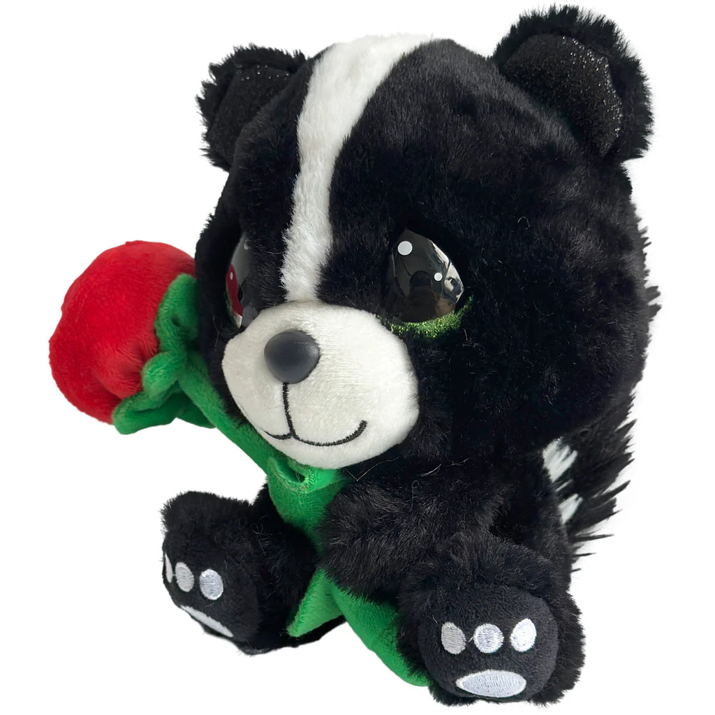 Plush toy skunk holding a red rose on a white background