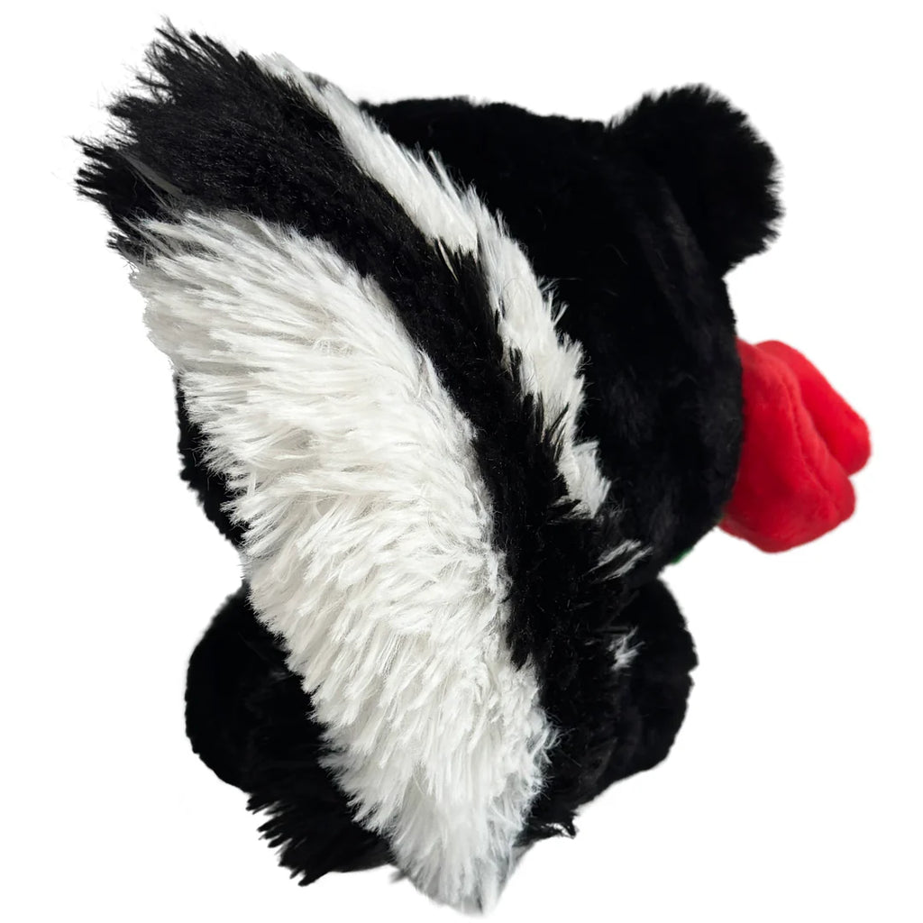 Plush toy resembling a skunk with a red nose on a white background