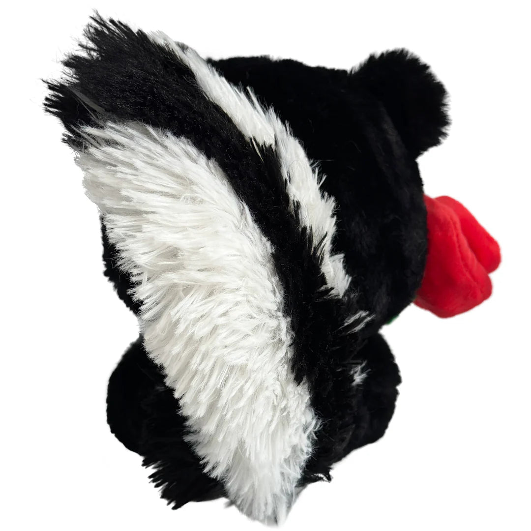 Plush toy resembling a skunk with a red nose on a white background