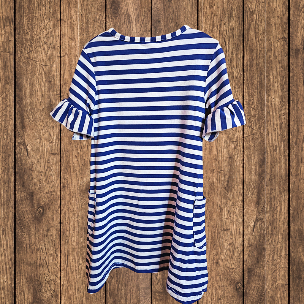 Blue and white striped dress on a wooden background