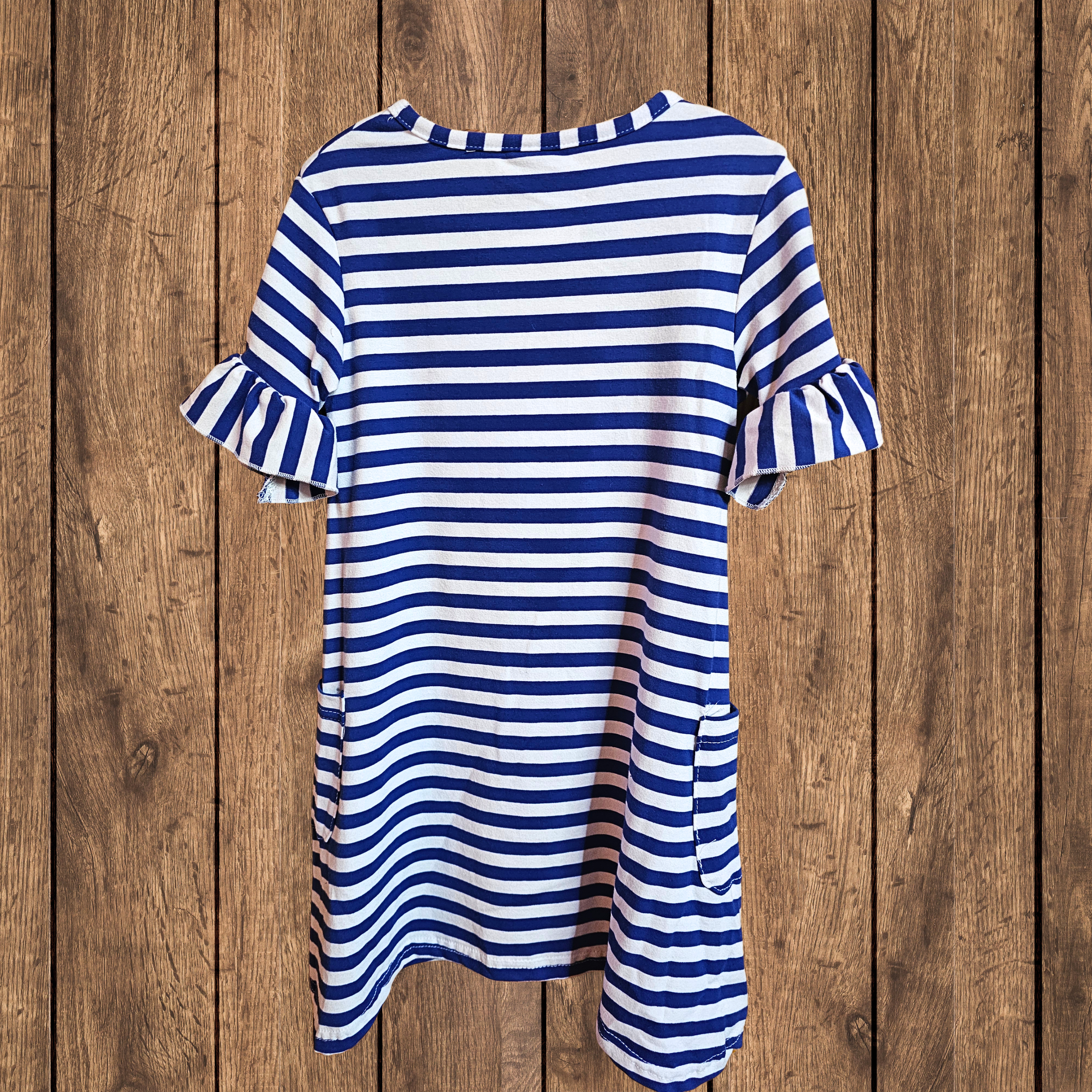 Blue and white striped dress on a wooden background