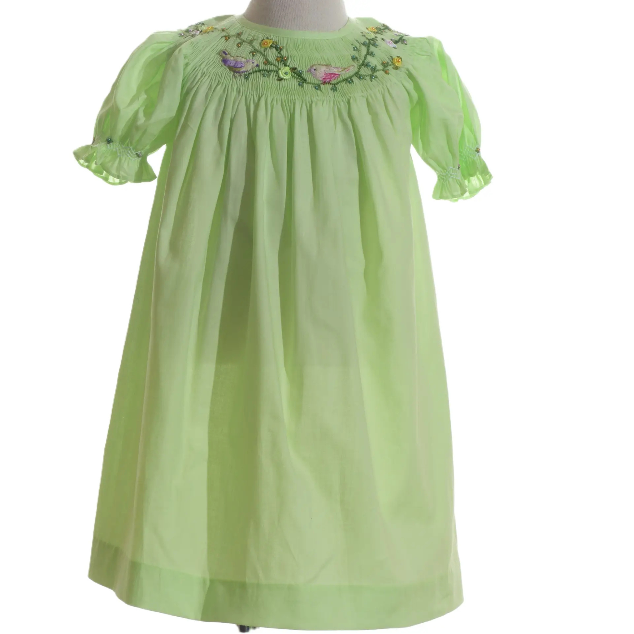 Green dress with floral embroidery on a white background
