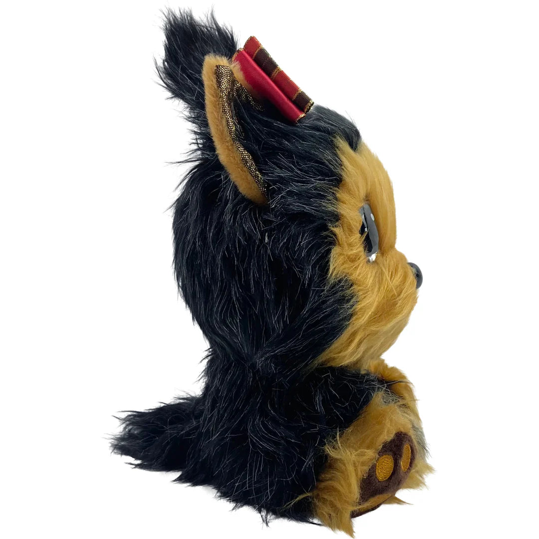 Plush toy resembling a dog with black and brown fur on a white background