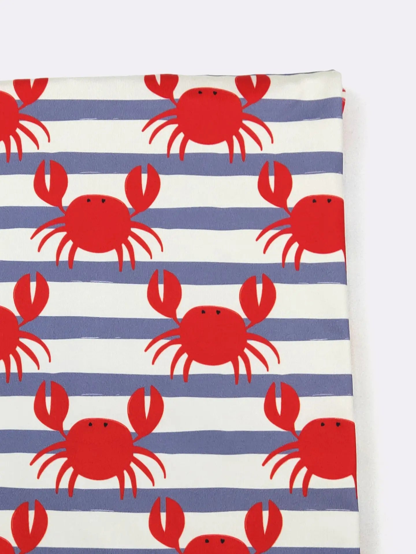 Fabric with red crab pattern on blue and white striped background