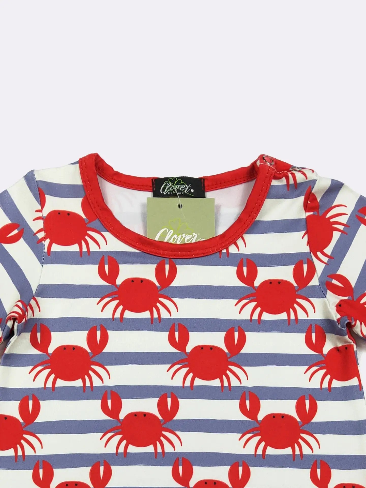 Children's shirt with red crab pattern on a white and blue striped background