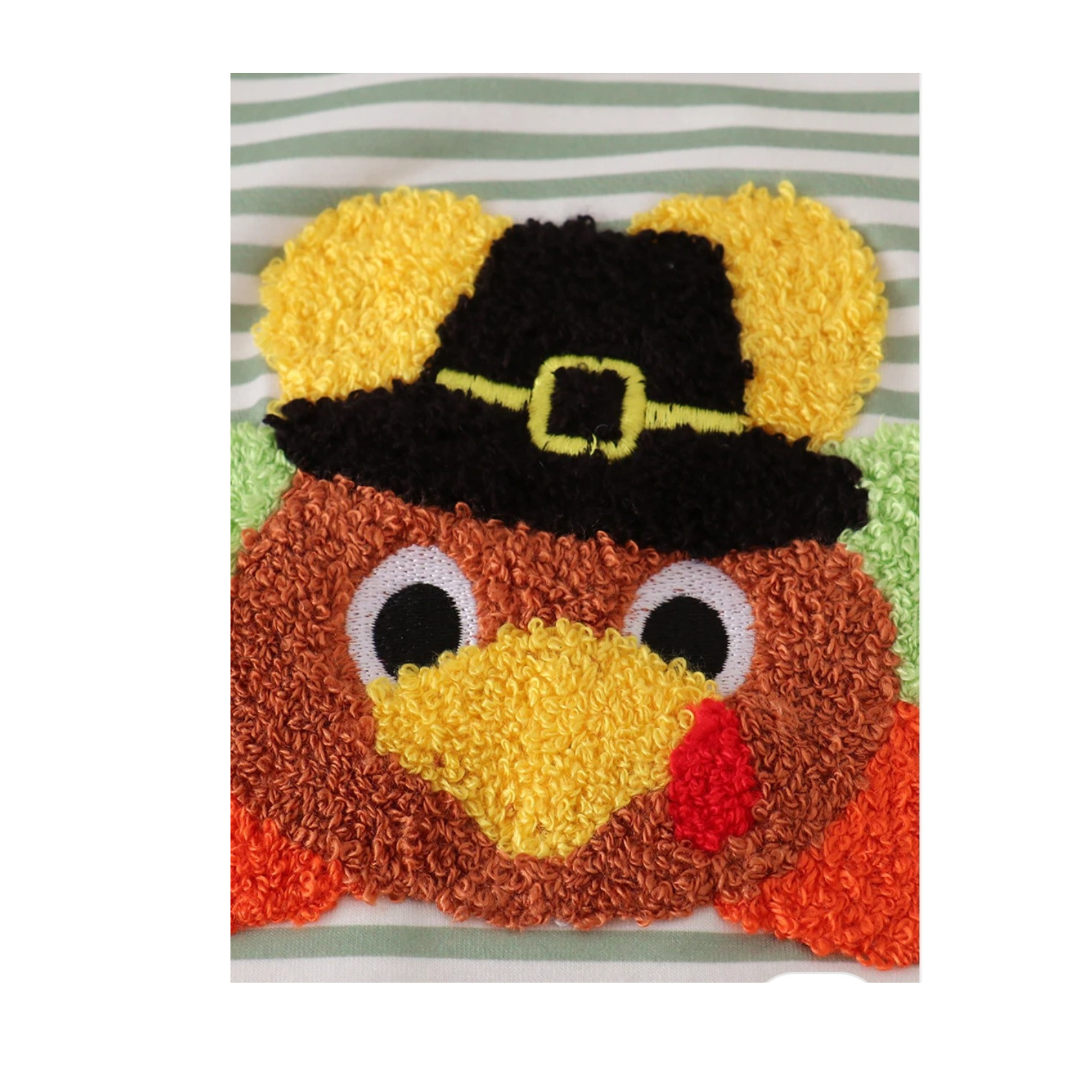 Turkey-shaped pillow with a pilgrim hat on a striped background