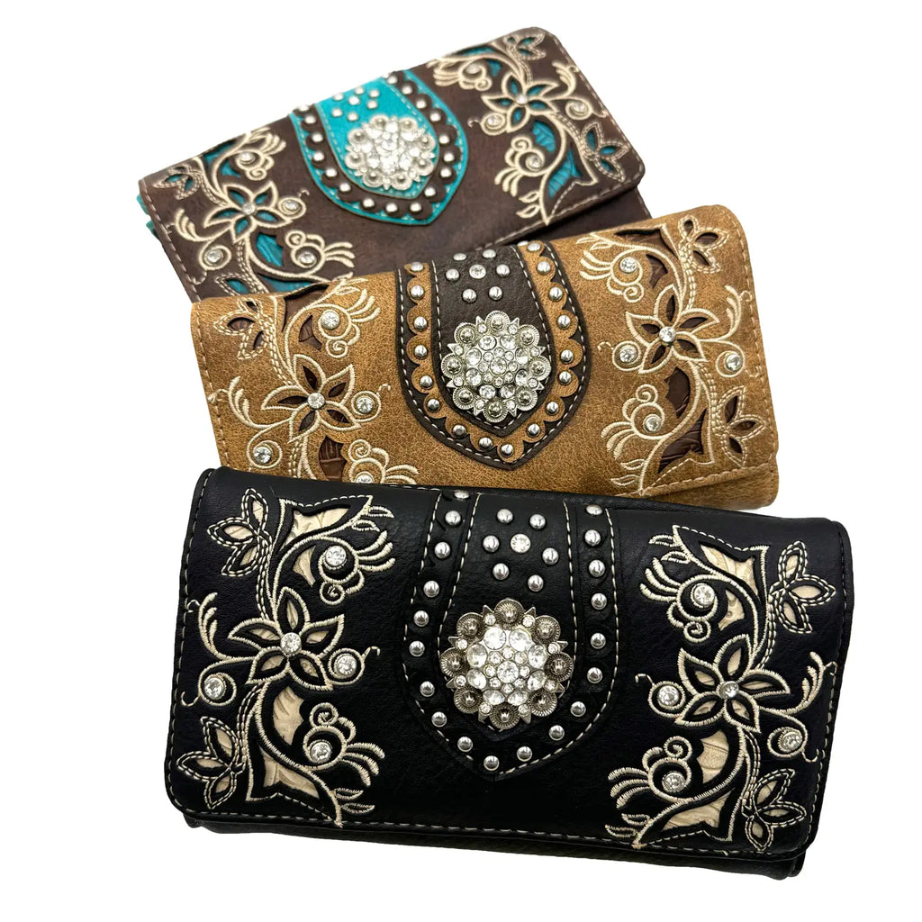 Three decorative crossbody wallets with floral patterns and embellishments on a white background