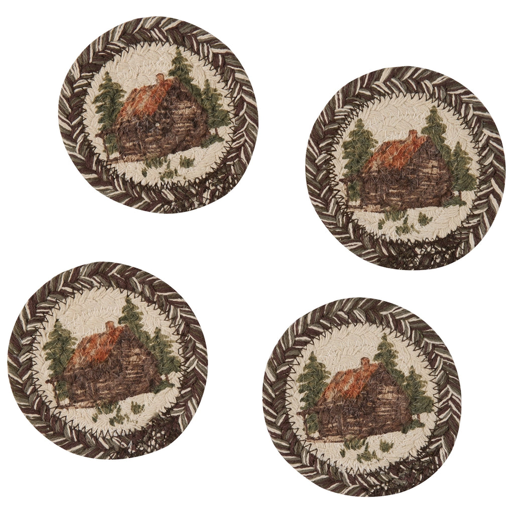 Set of four round coasters with a cabin design on a white background