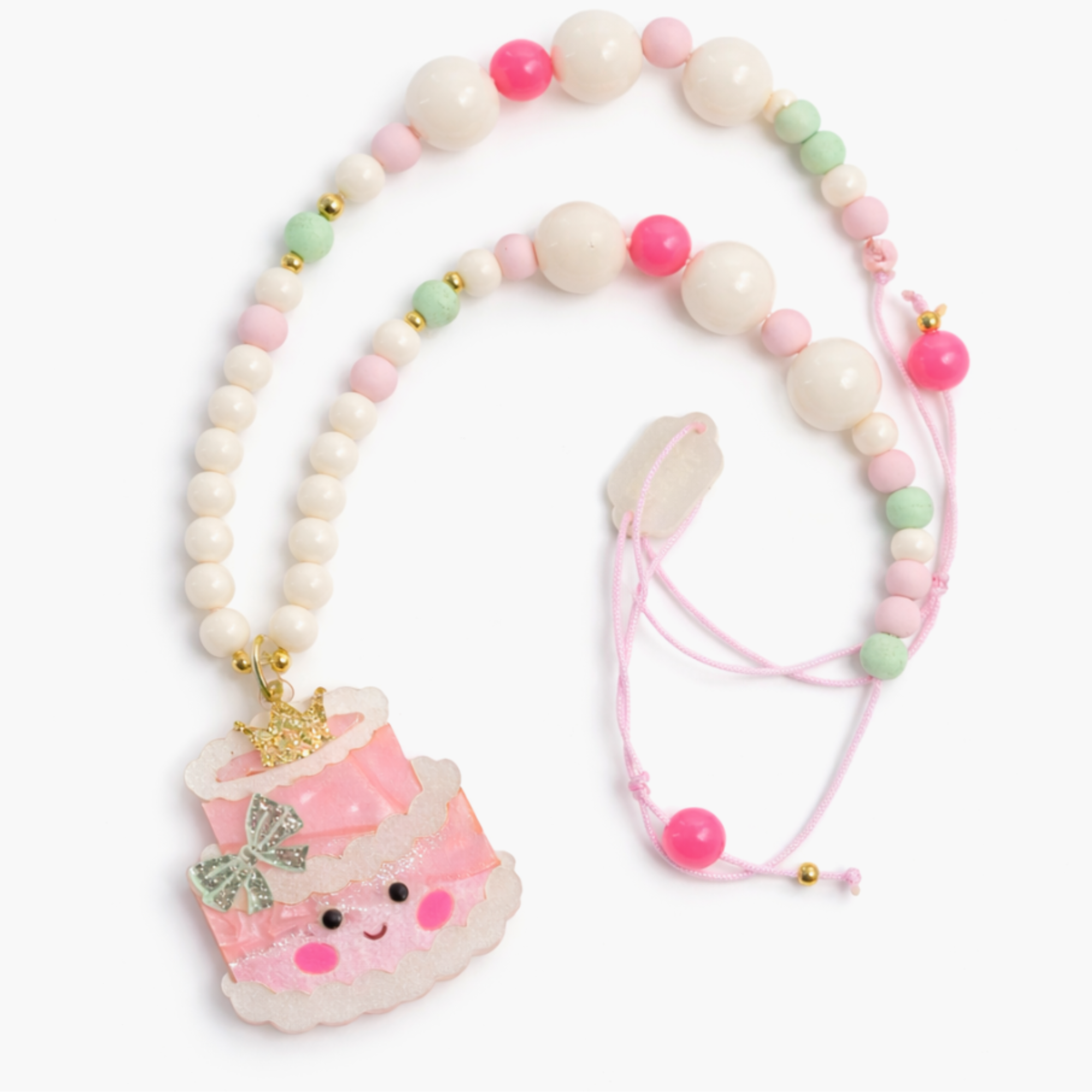 Necklace with a pink cake charm on a white background