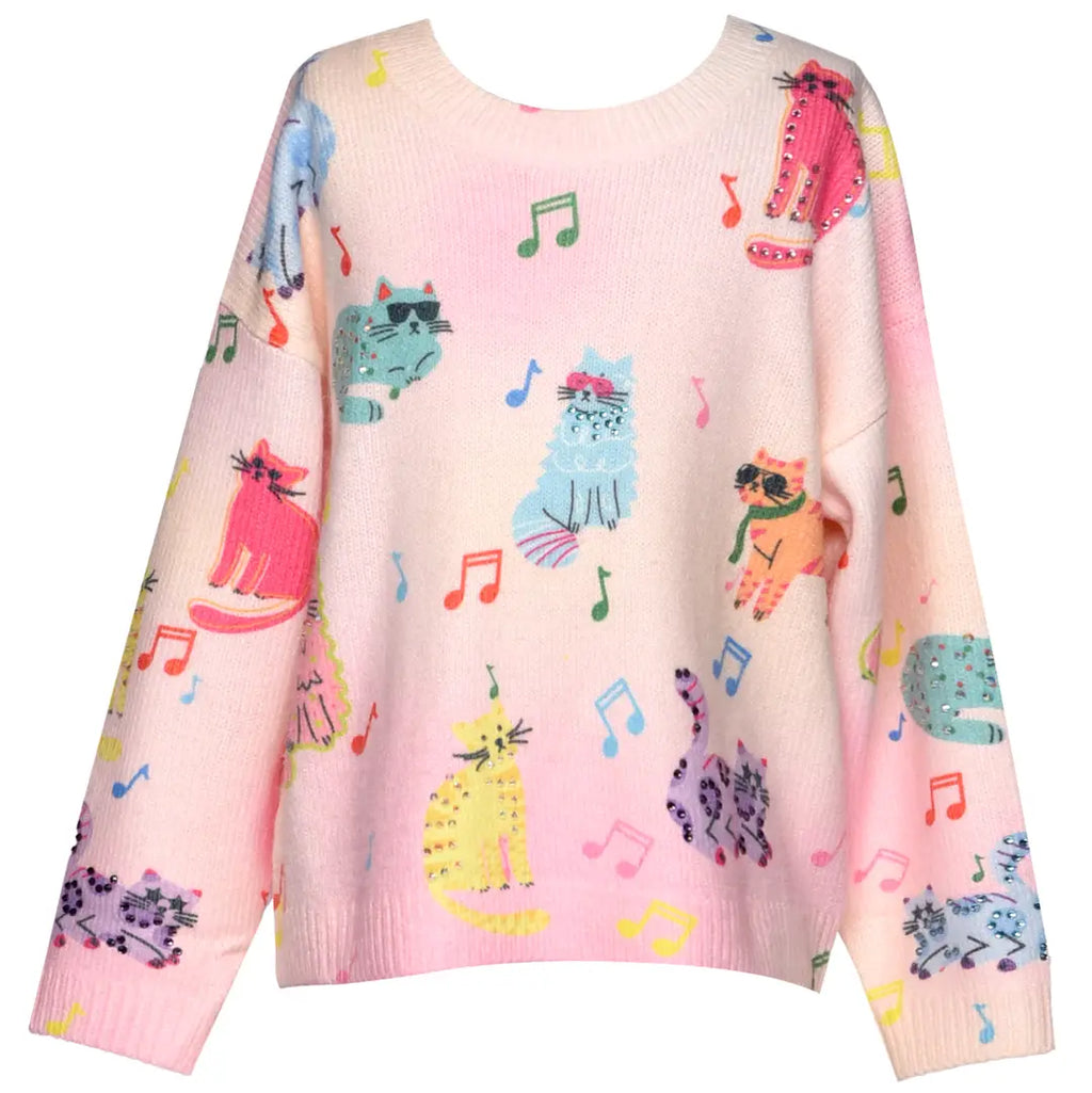 Pink sweater with colorful cat and music note patterns on a white background