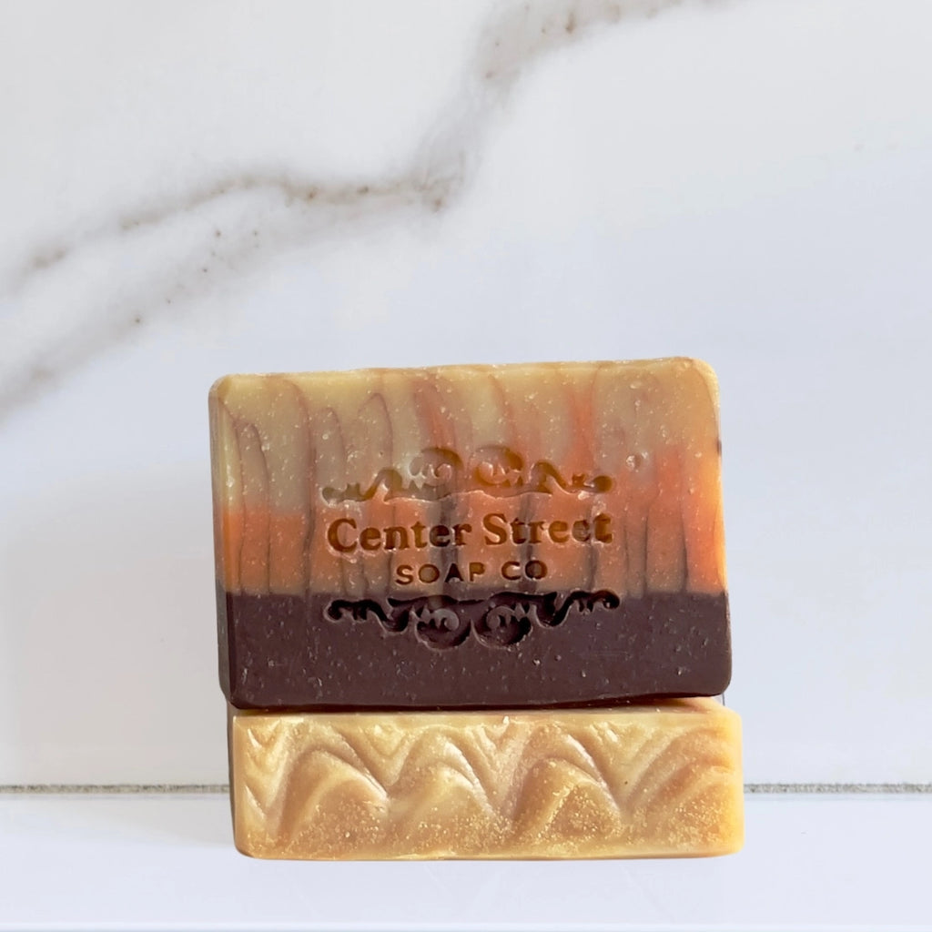 Three layered soap bar with 'Center Street Soap Co' branding on a marble background