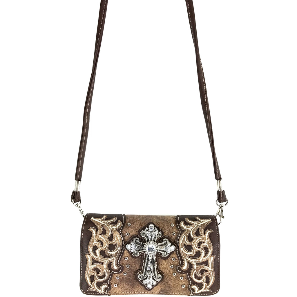 Brown leather wallet clutch with intricate designs and a central cross emblem on a white background.