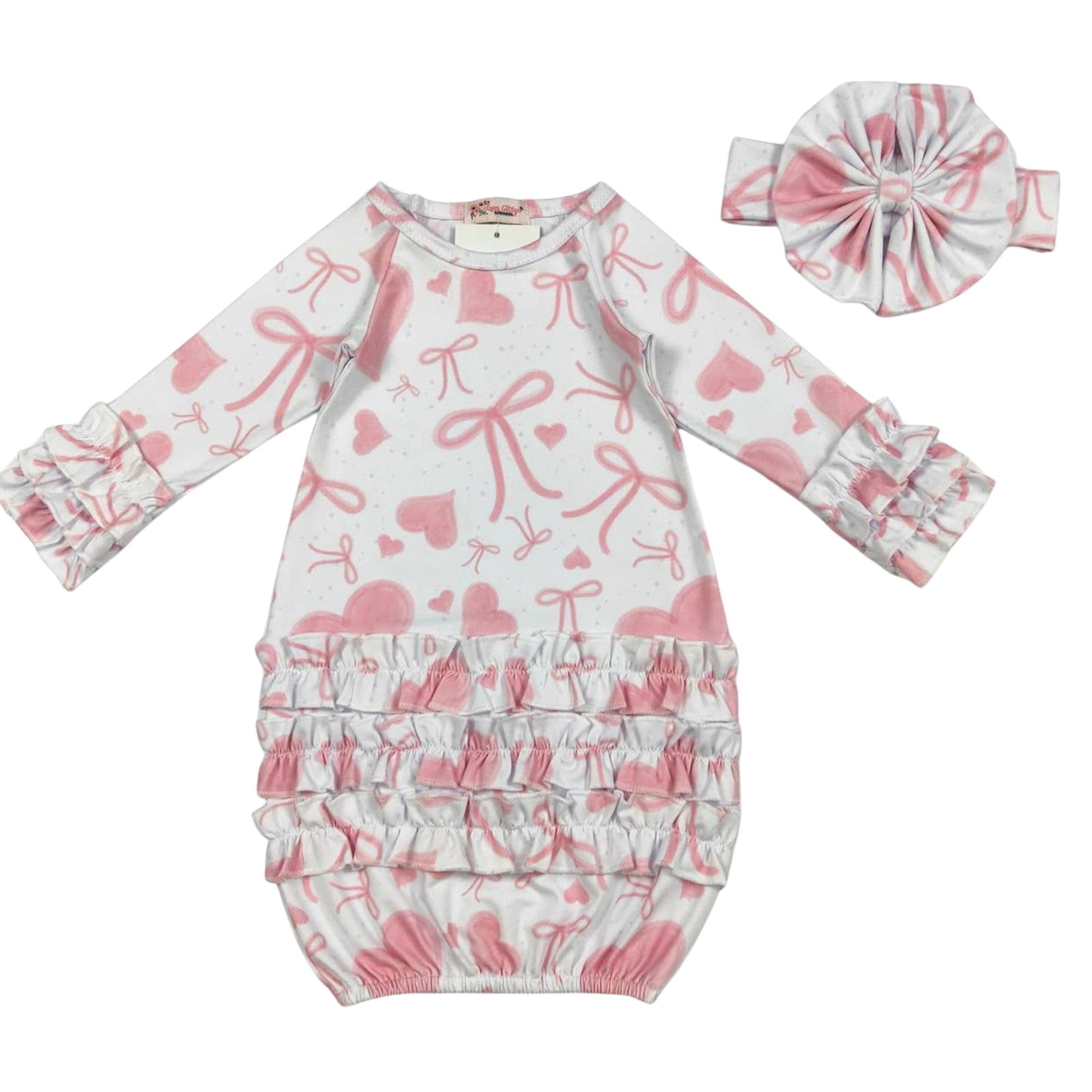 Baby outfit set with pink bows and hearts on a white background