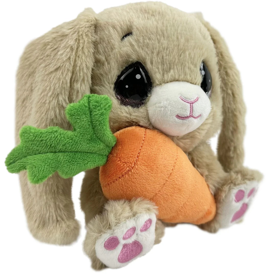 Plush toy rabbit holding a carrot with green leaves on a white background