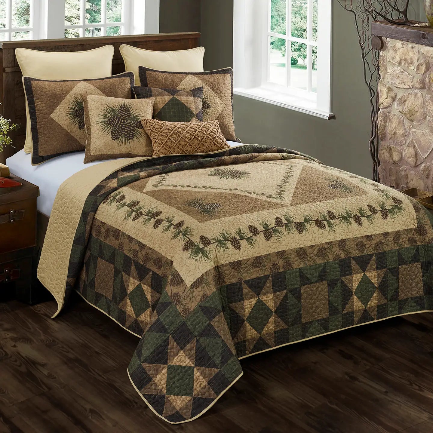 Bed with a quilt and pillows featuring nature-themed patterns in a bedroom setting.