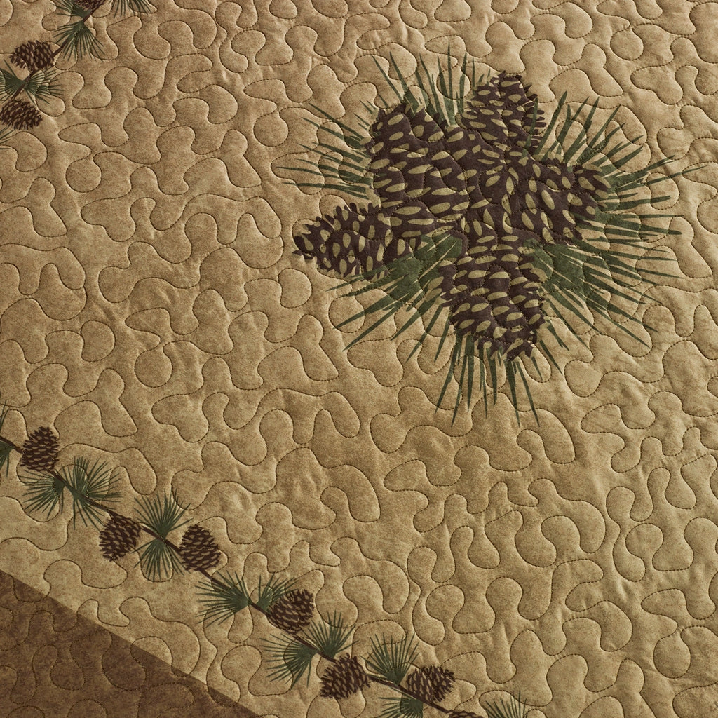 Textured fabric with embroidered pinecones and branches on a beige background