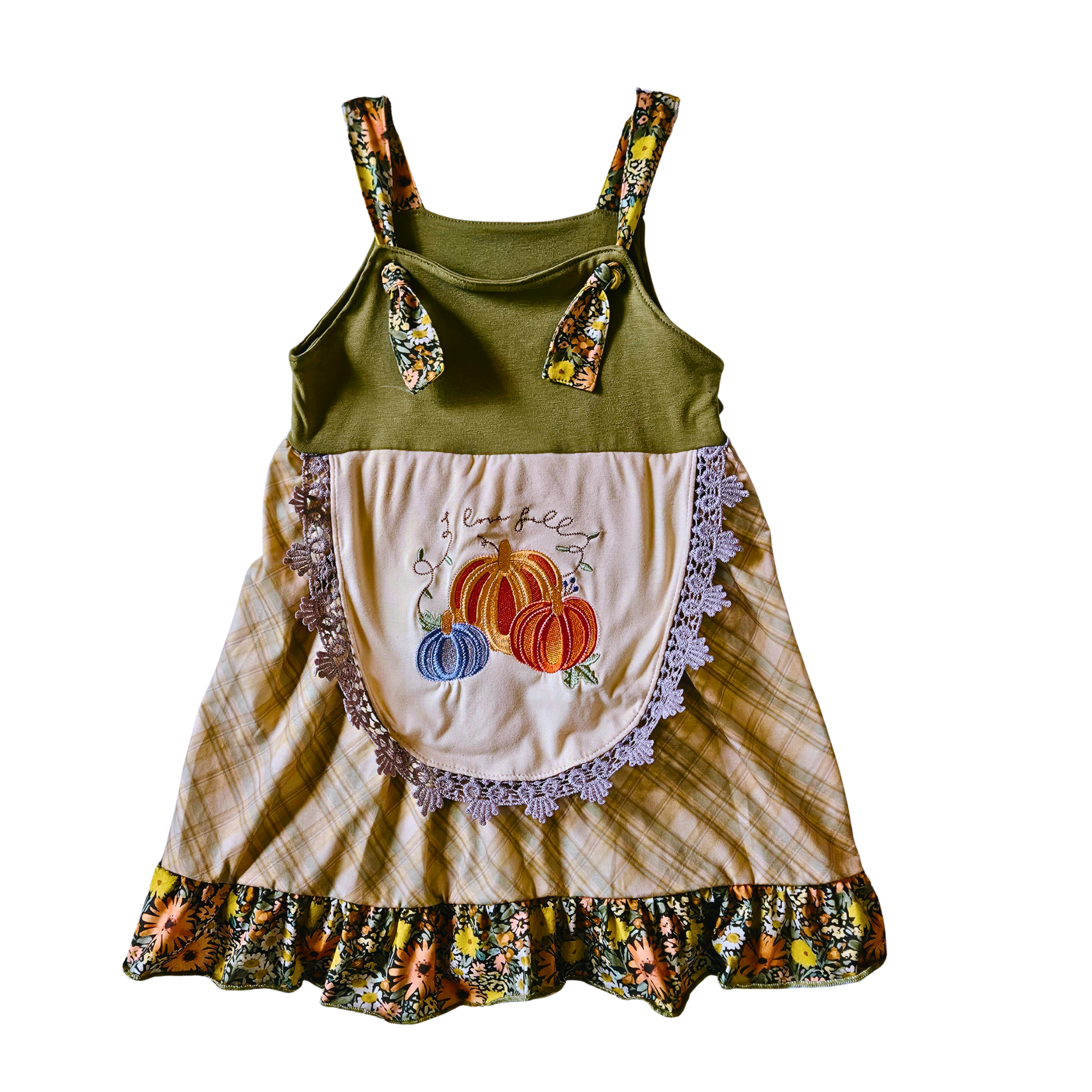 Children's dress with green top and floral straps, beige skirt with pumpkin design, on a white background.