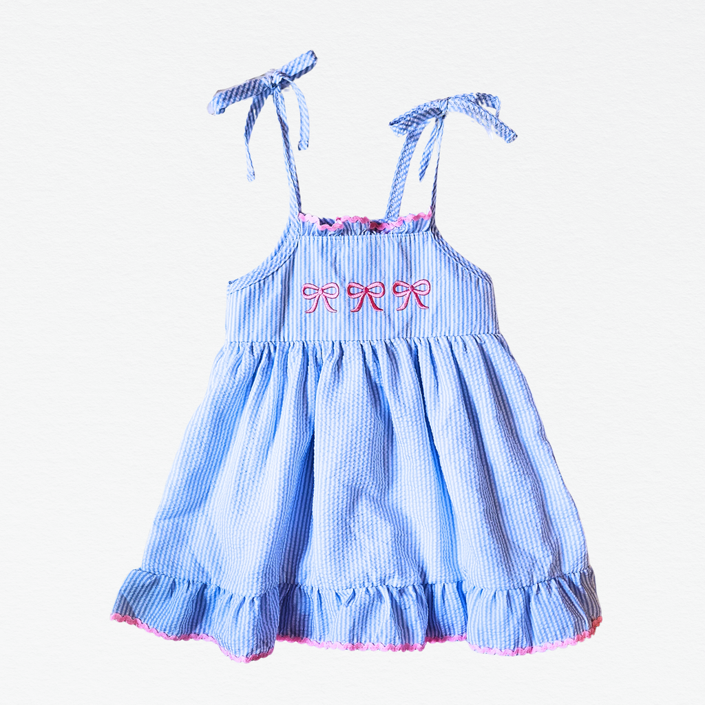 Blue checkered dress with pink accents on a white background