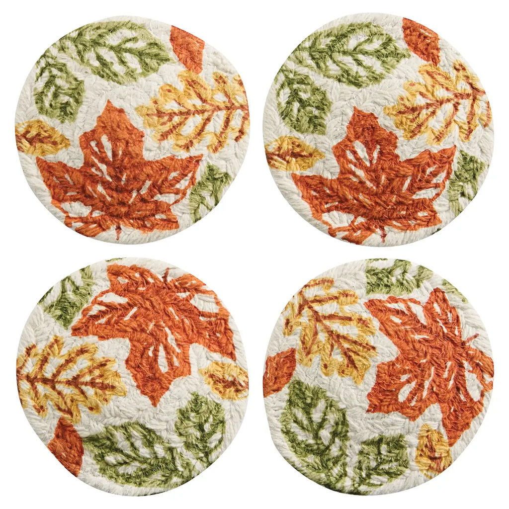 Four round coasters with autumn leaf pattern on a white background