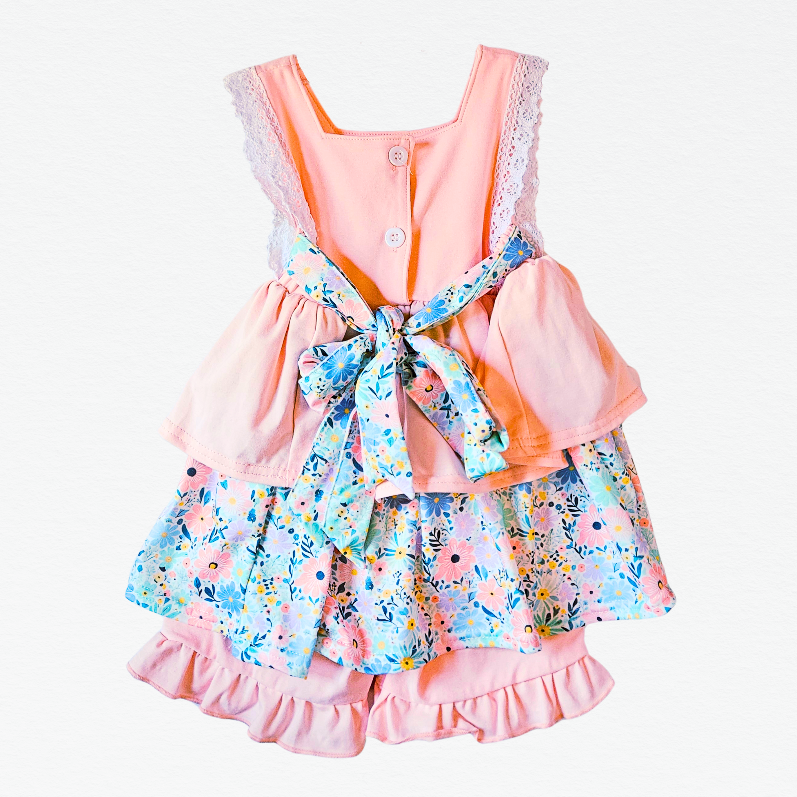 Children's dress with floral shorts and pink top on a white background