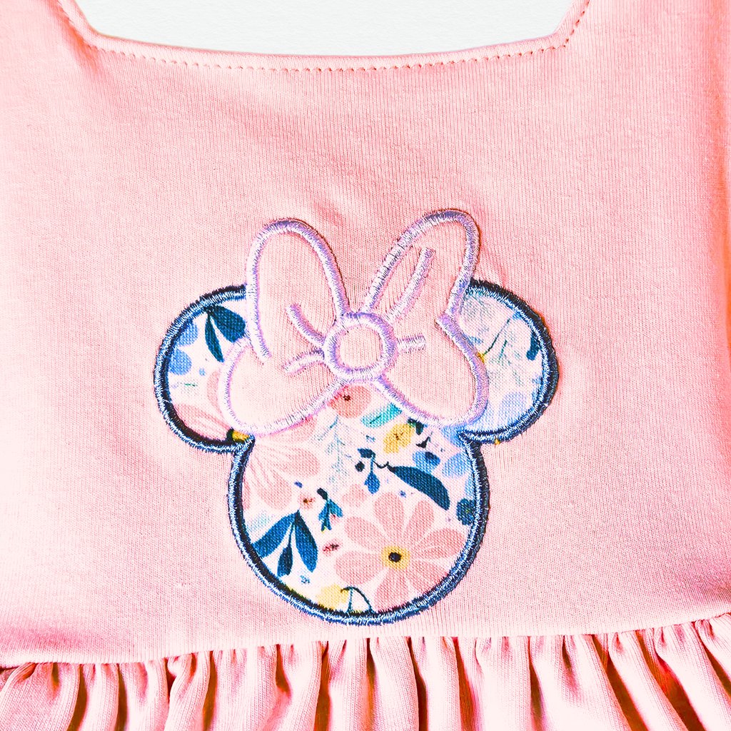 Pink top with floral bow design on a white background