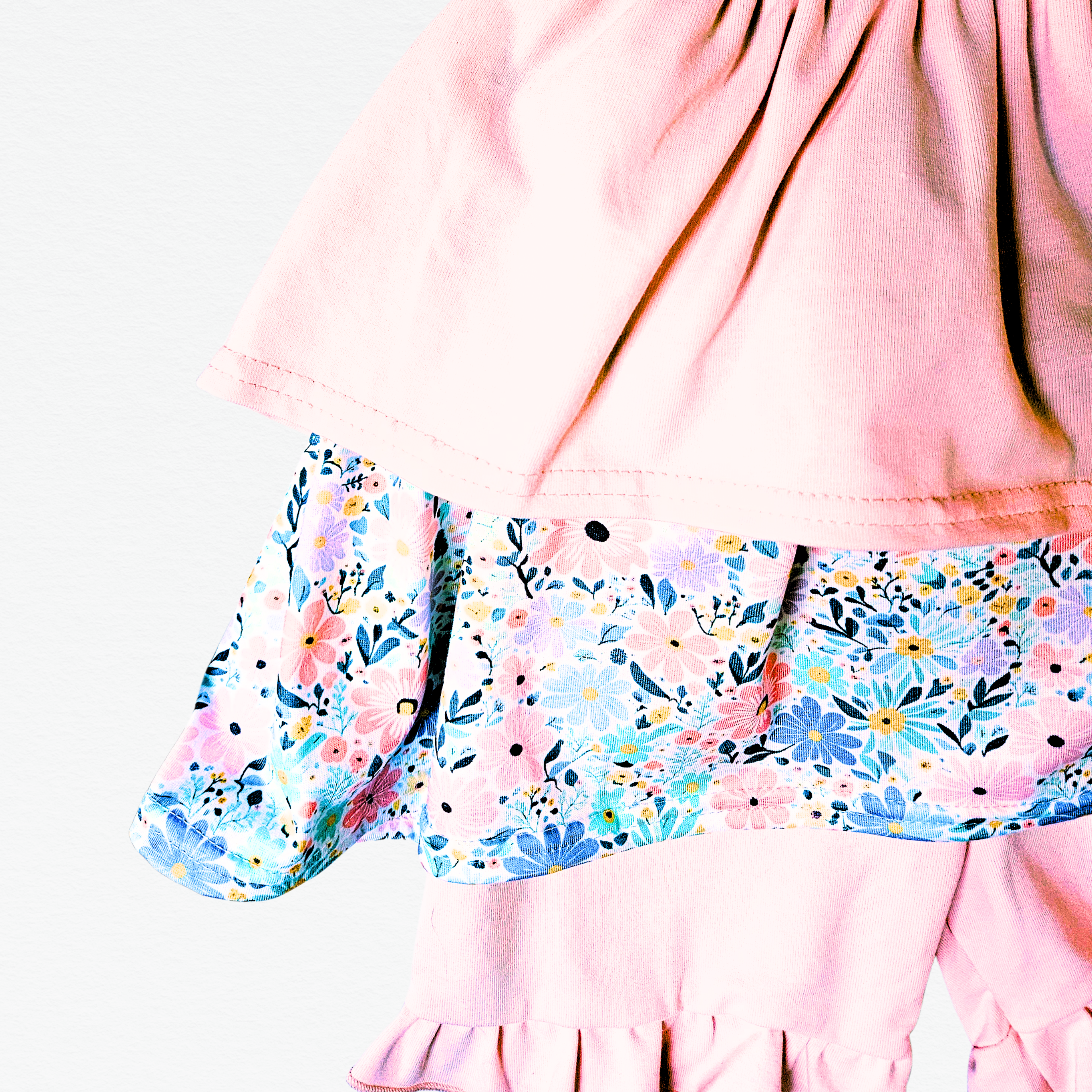 Pink dress with floral top and shorts on a white background