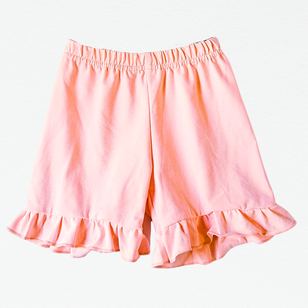 Pink shorts with ruffled hem on a white background