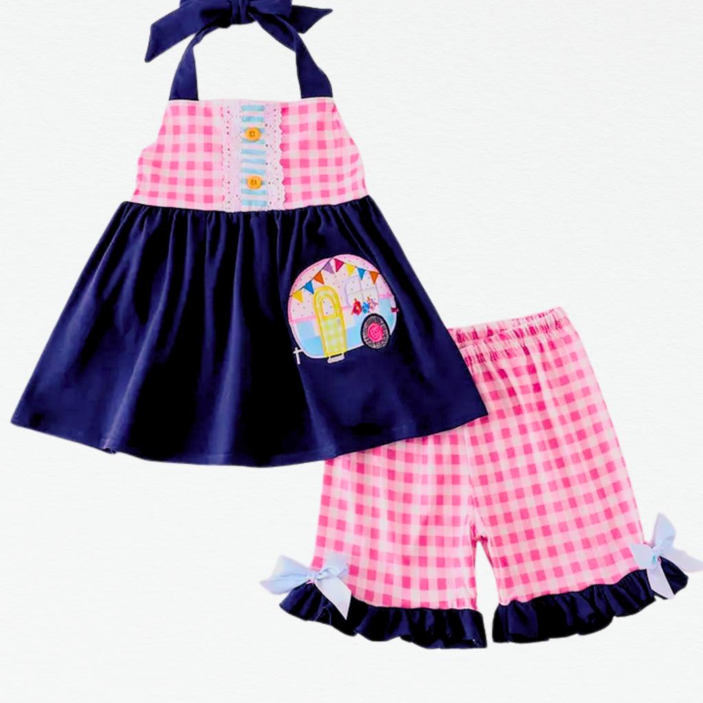 Children's outfit with pink and navy checkered top and shorts on a white background