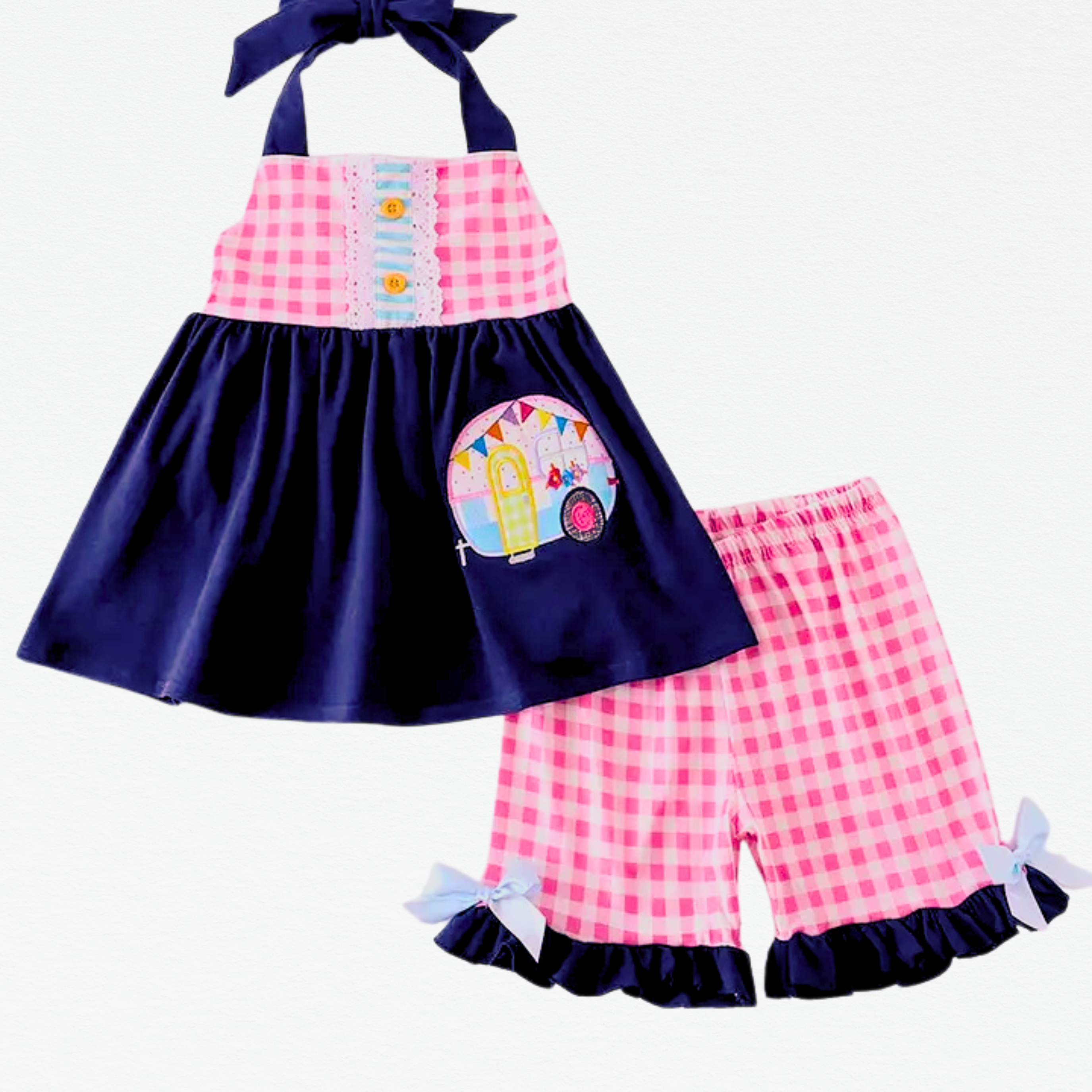 Children's outfit with pink and navy checkered top and shorts on a white background