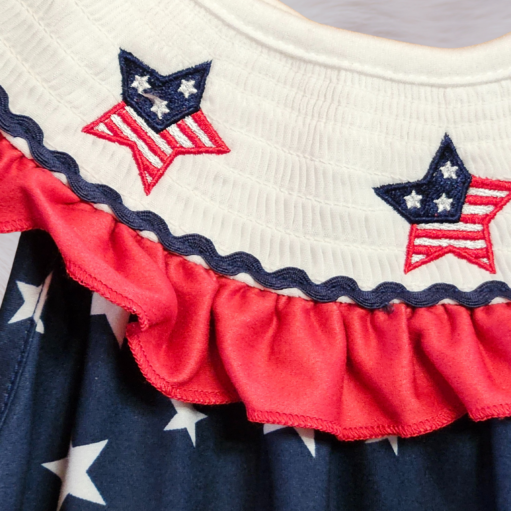 Close-up of a dress with red, white, and blue star patterns on a white background