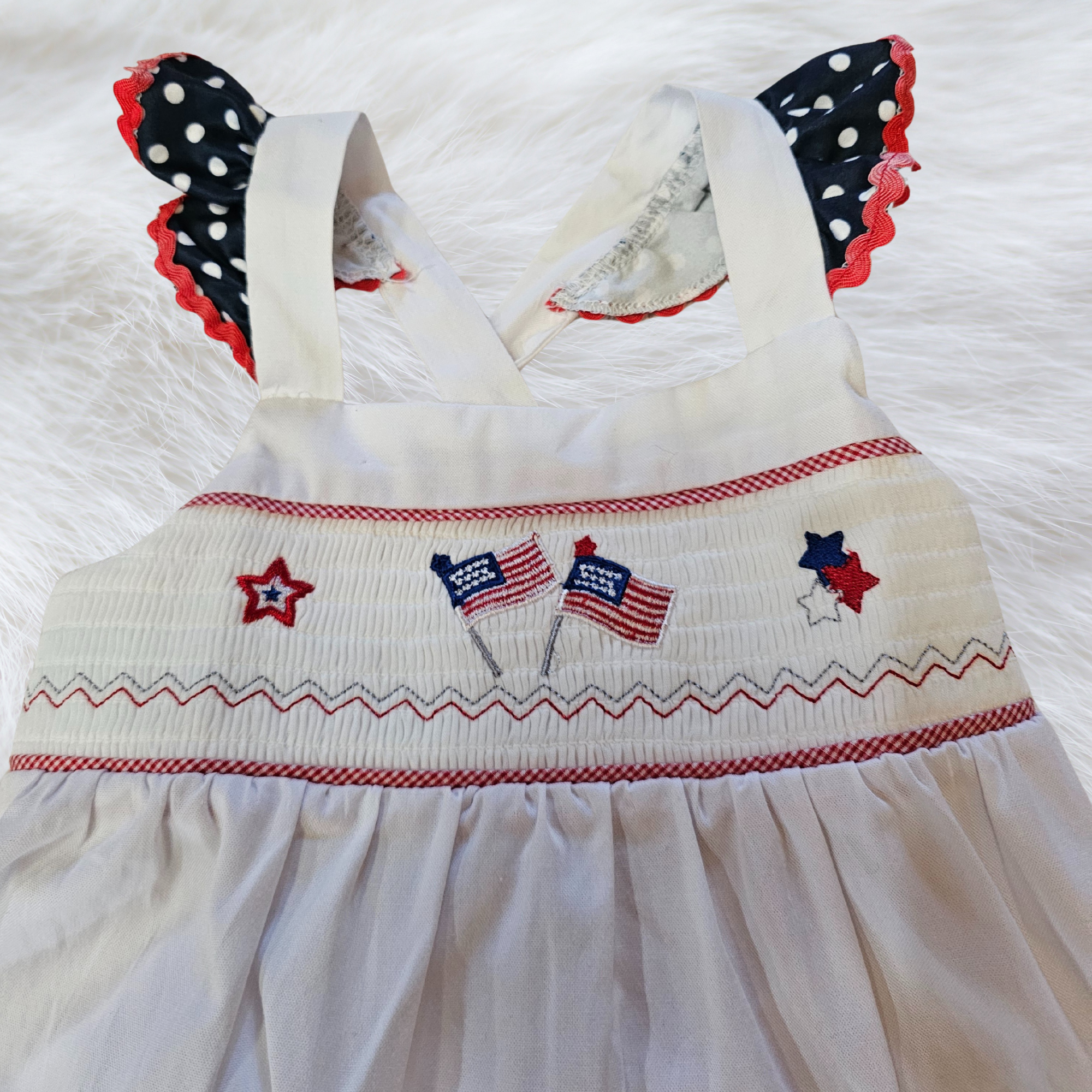 White dress with red, white, and blue accents on a white background