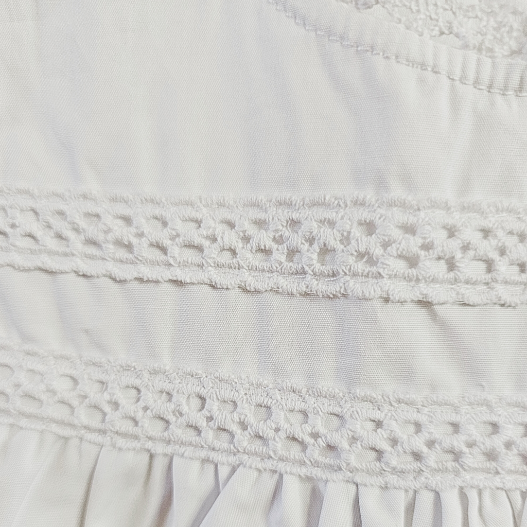 Close-up of a white fabric with lace detailing