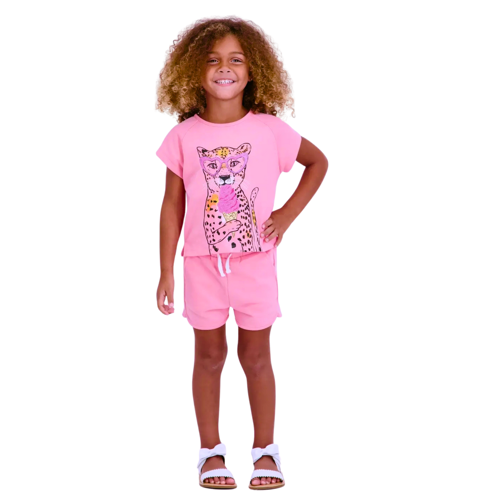 Child wearing a pink outfit with a leopard print design on a white background