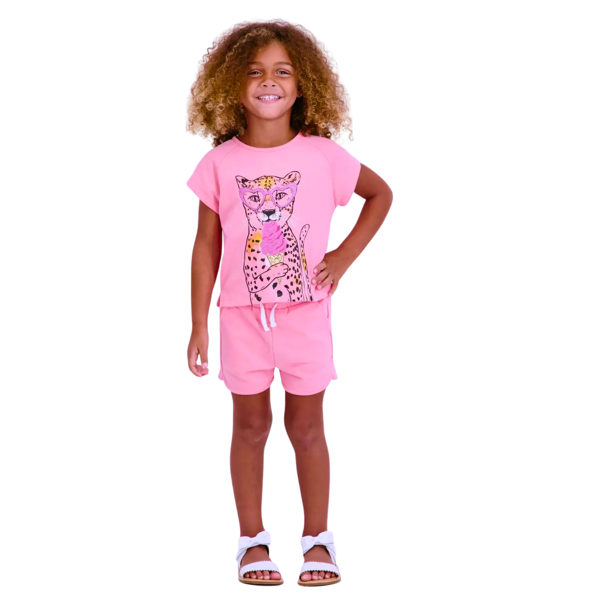 Child wearing a pink outfit with a leopard print design on a white background
