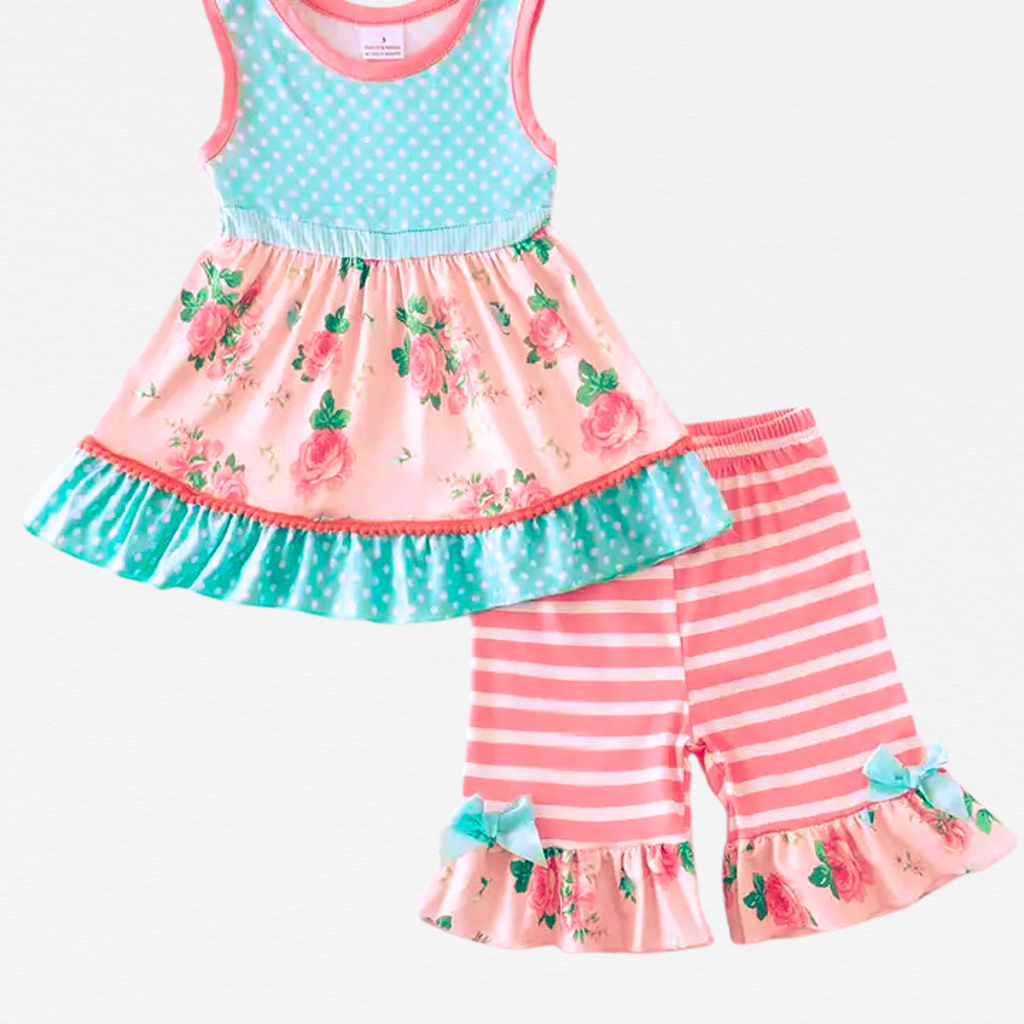 Children's outfit with floral top and striped pants on a white background