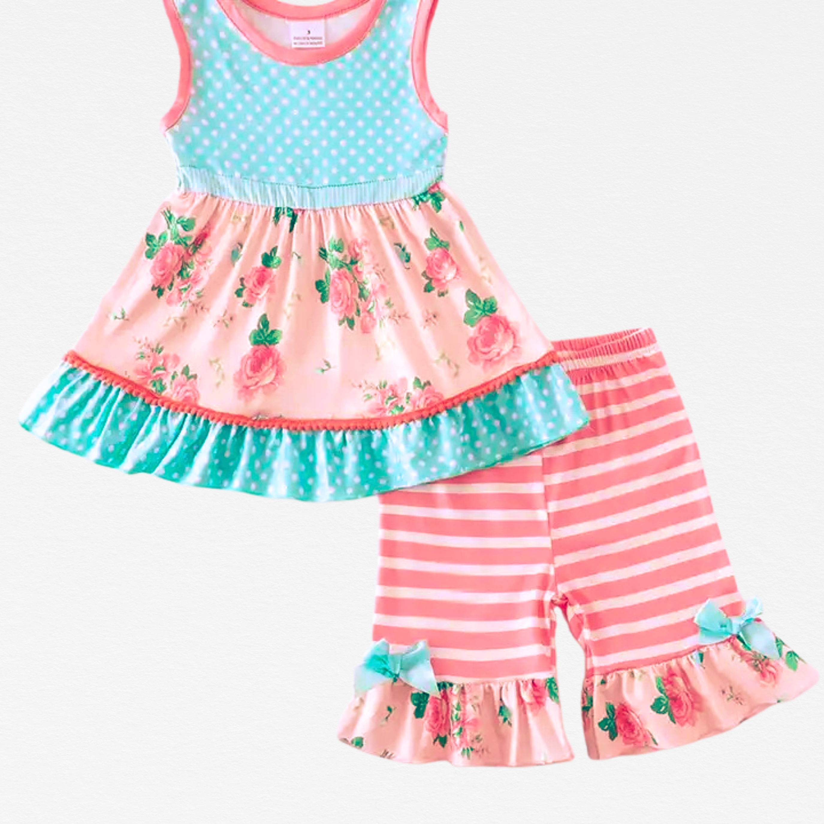 Children's outfit with floral top and striped pants on a white background