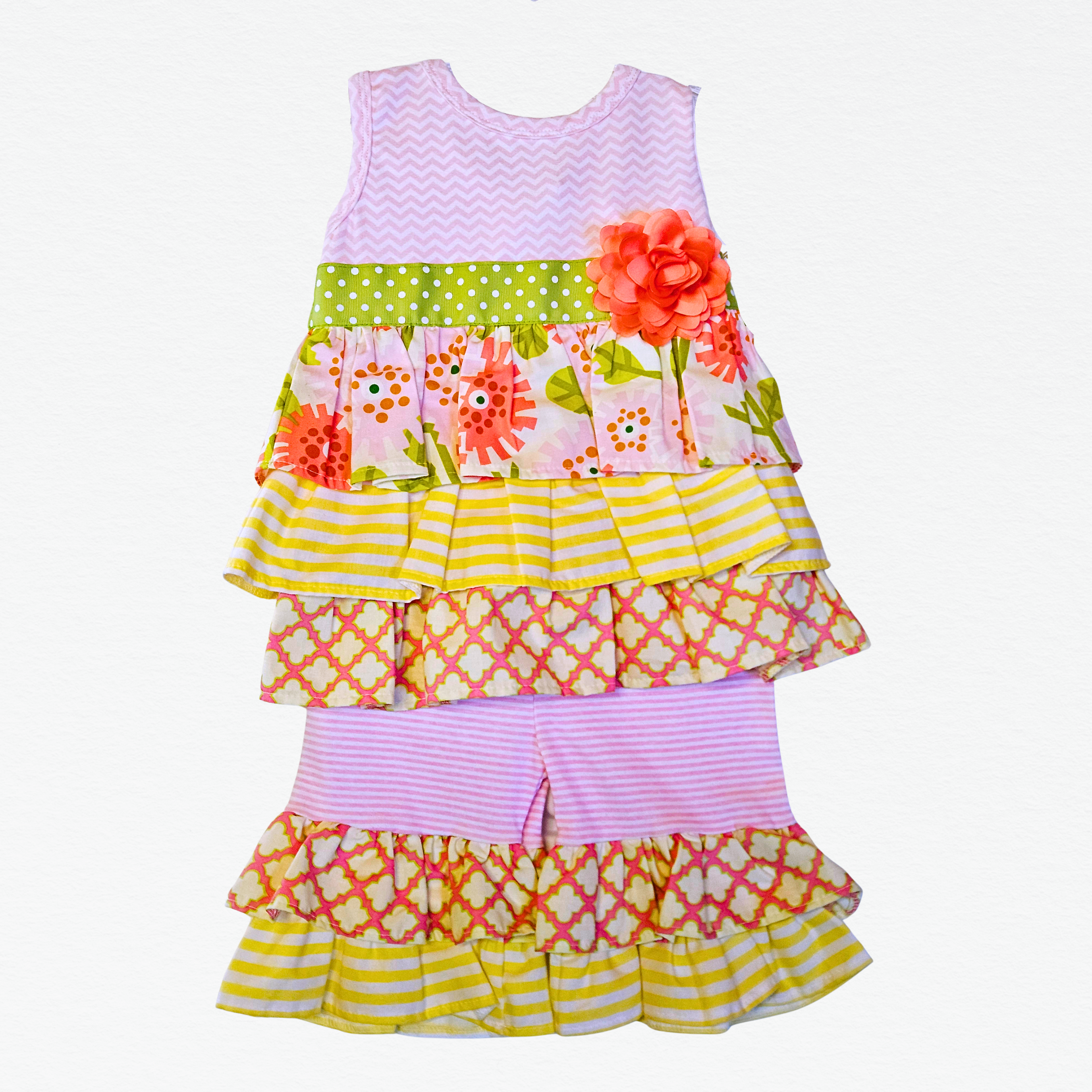 Colorful children's outfit with floral and geometric patterns on a white background