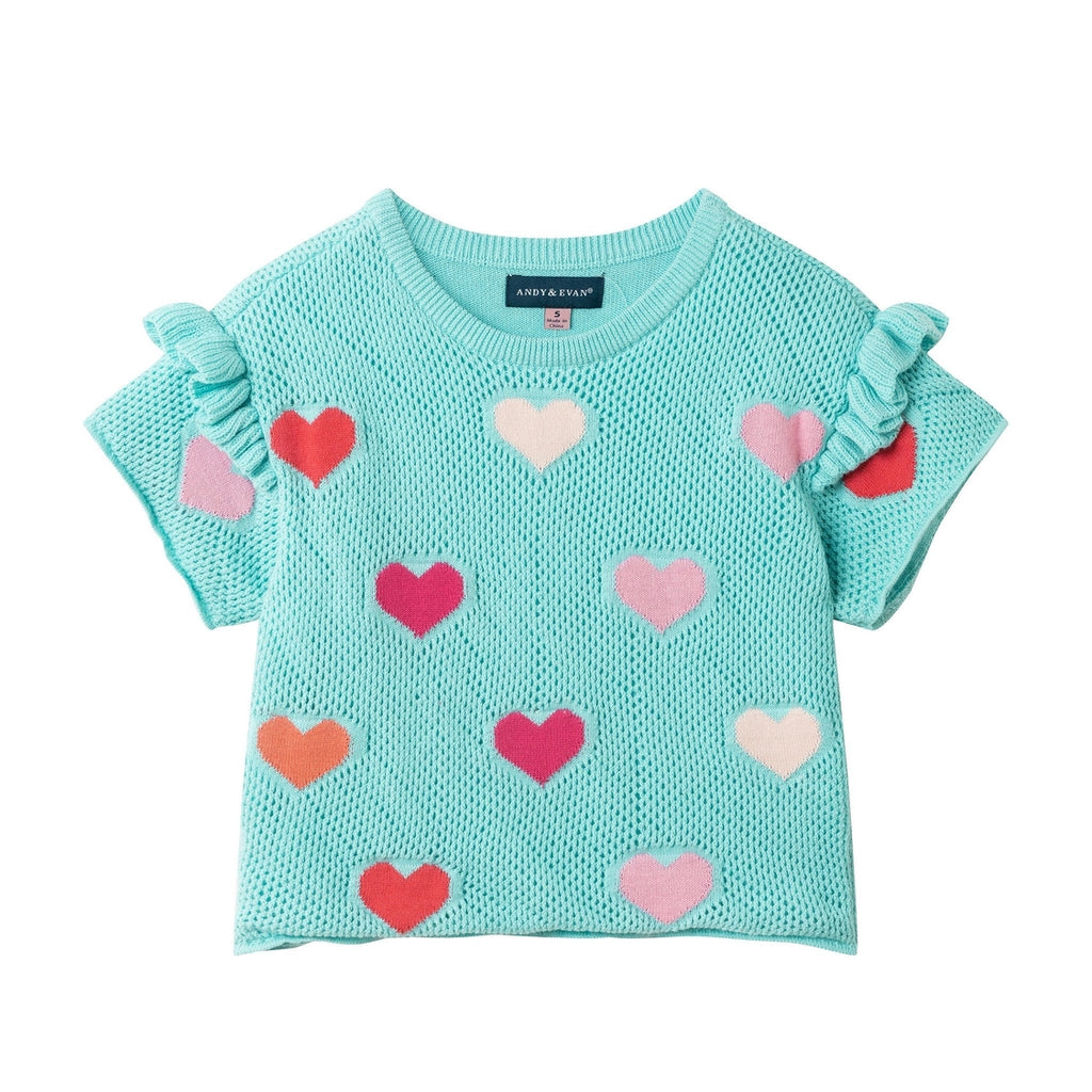 Light blue sweater with heart patterns on a white background