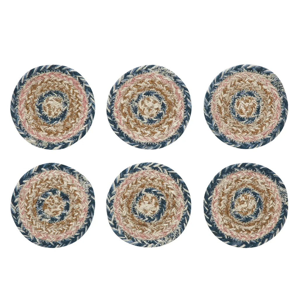 Set of six round woven coasters with a spiral pattern on a white background