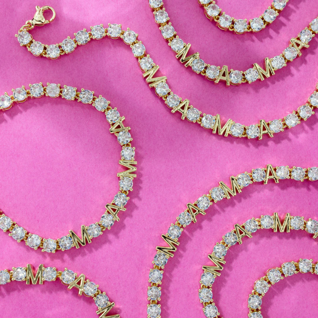 Gold and diamond bracelet on a pink background